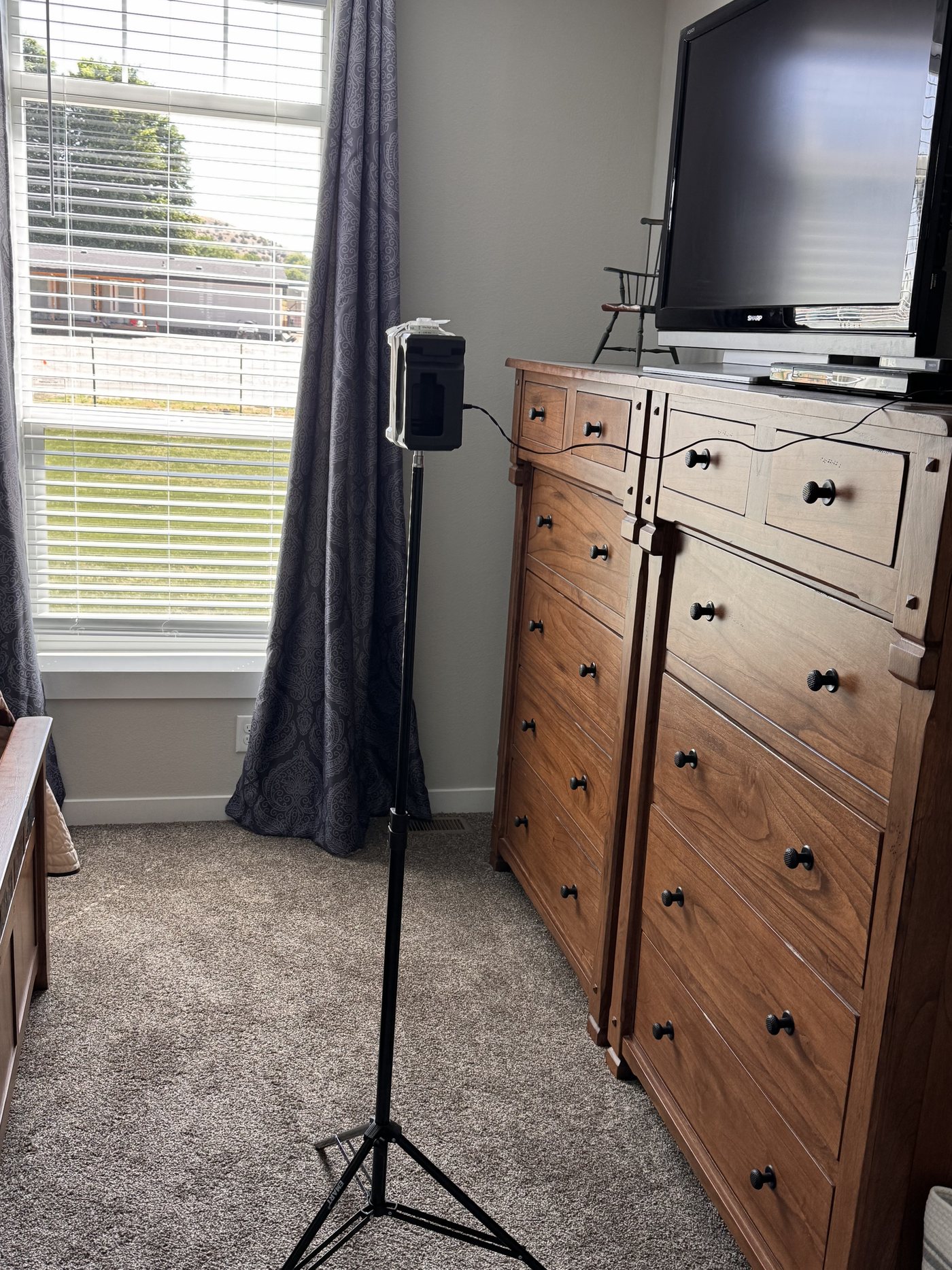 Air sampling pump set up on a tripod inside a home during a mold assessment