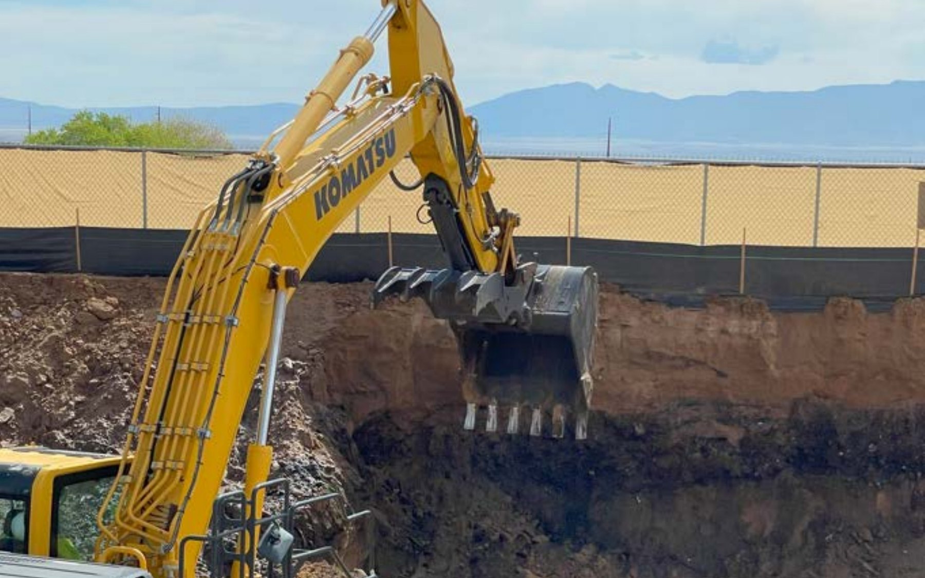 DEKON Komatsu PC360 excavator at large-scale asbestos soil excavation site