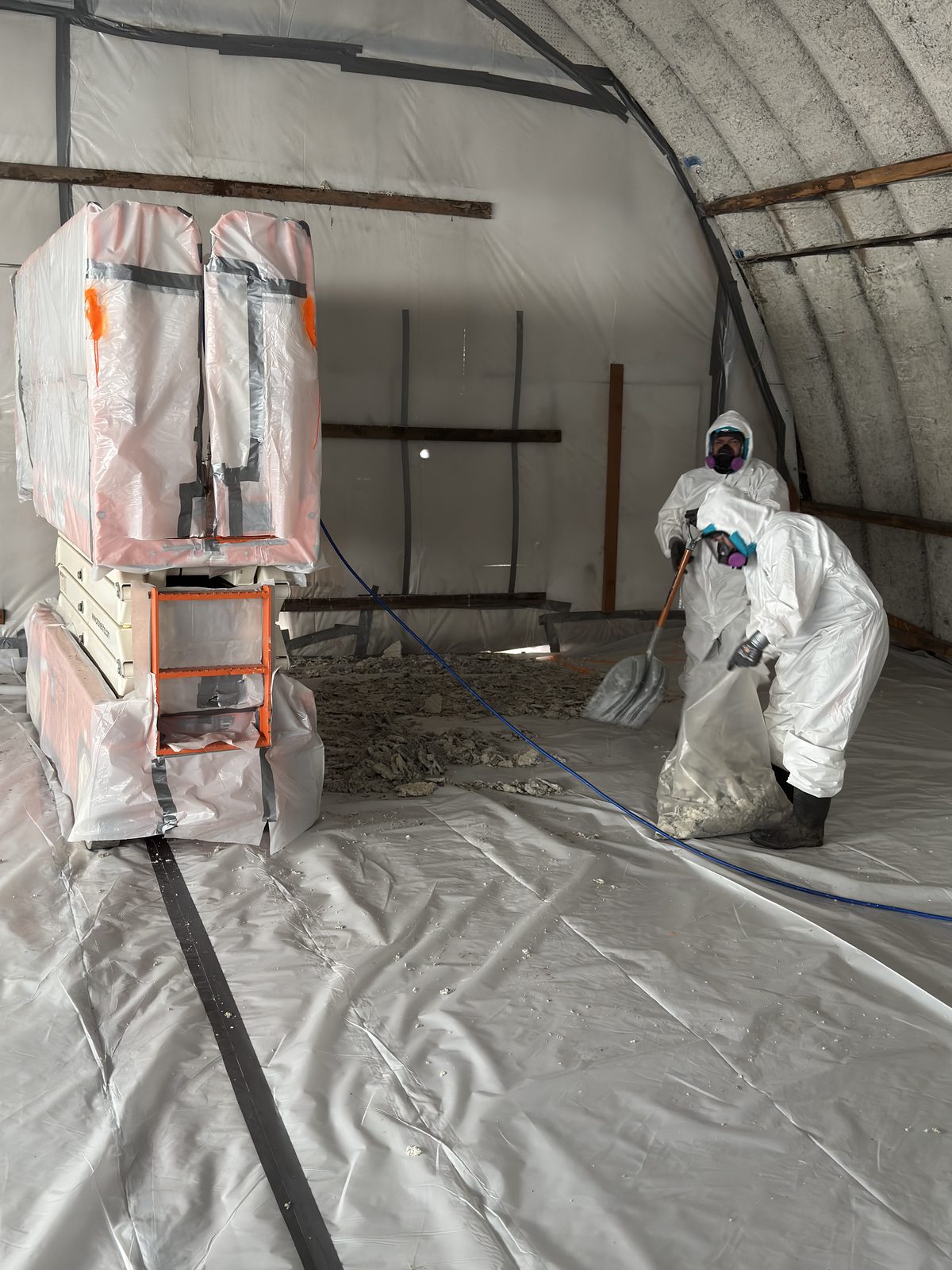 Suited crew inside full containment