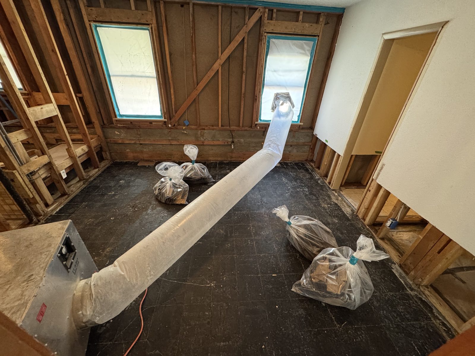 Flooring removal underway with negative air ducted out