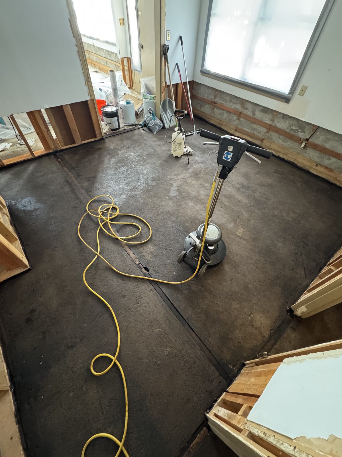 Floor buffer taking residual mastic off the slab