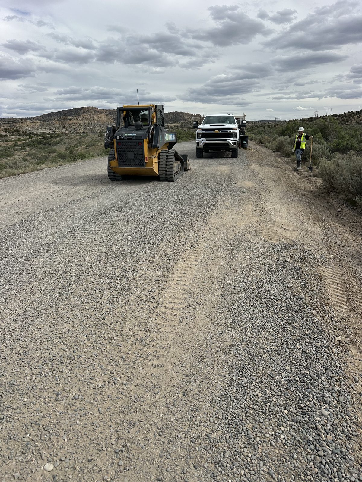Crew and skid steer working a shoulder release
